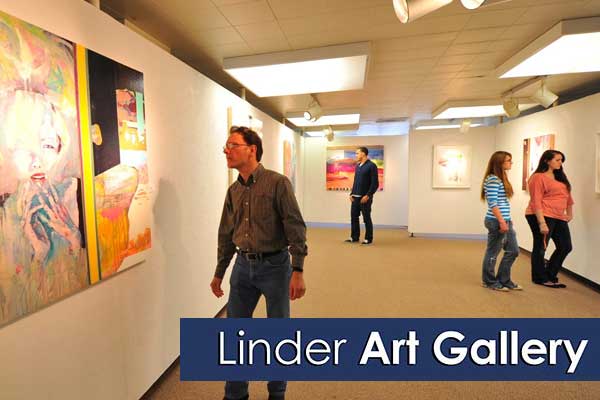 Four people admire art in the allery