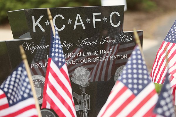 Keystone College Armed Forces Club monument surrounded by american flags