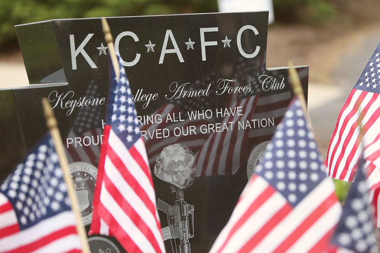 Flags surround the KCAFC memorial stone.