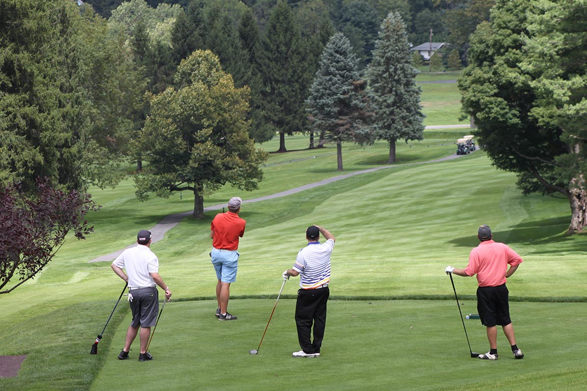 Four golfers look down the fareway