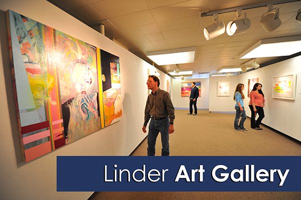 Four people admire art in the allery