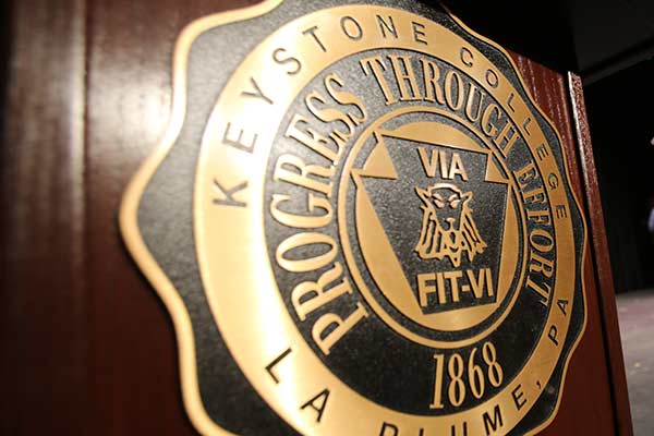 Keystone College seal on podium.
