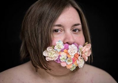 a woman with flowers in her mouth