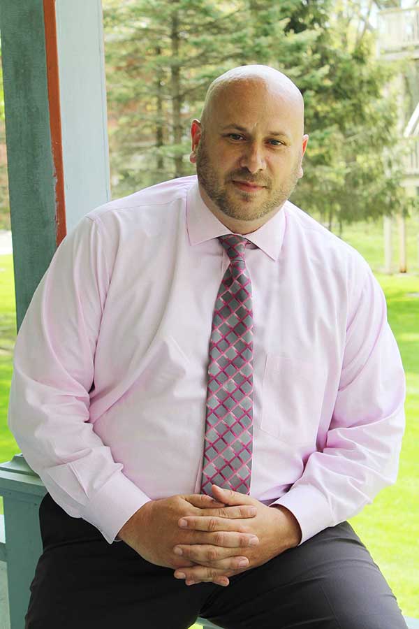 Jeremy Collins on the porch of Alumni Hall