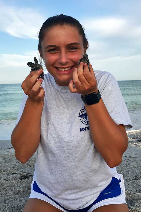 Kathryn Price holding turtles at her internship in Florida