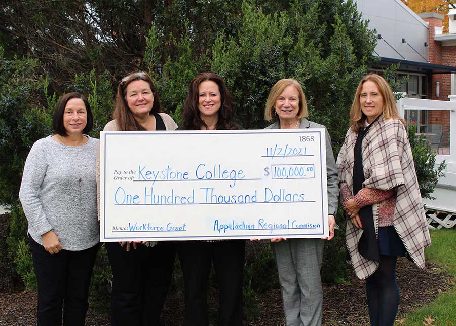 Members of Institutional Advancement display grant check