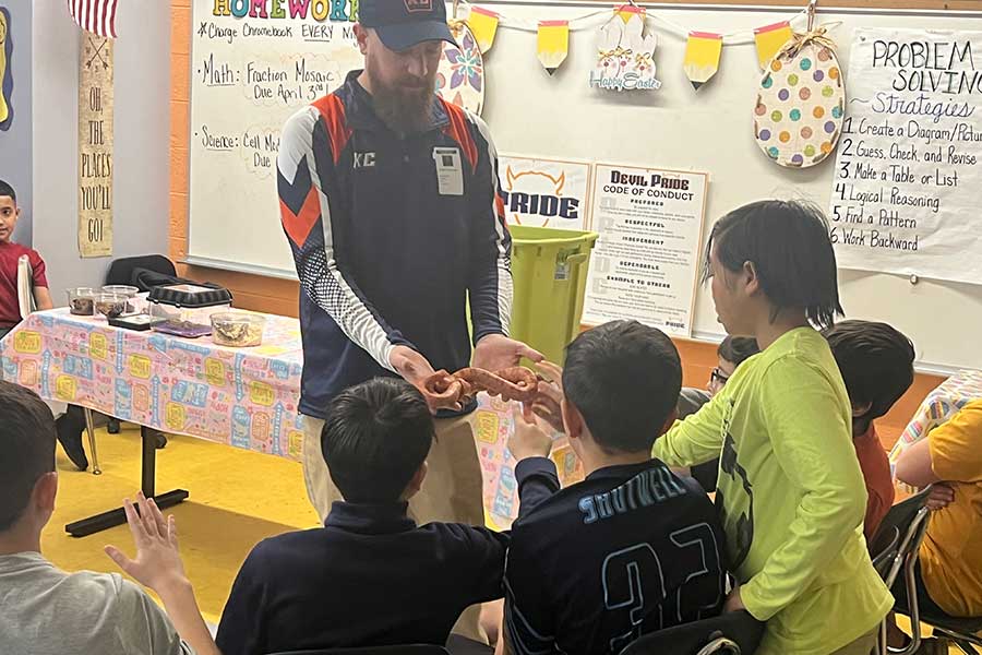 Assistant Professor Joseph Iacovazzi presents reptiles and arthropods to Old Forge elementary students